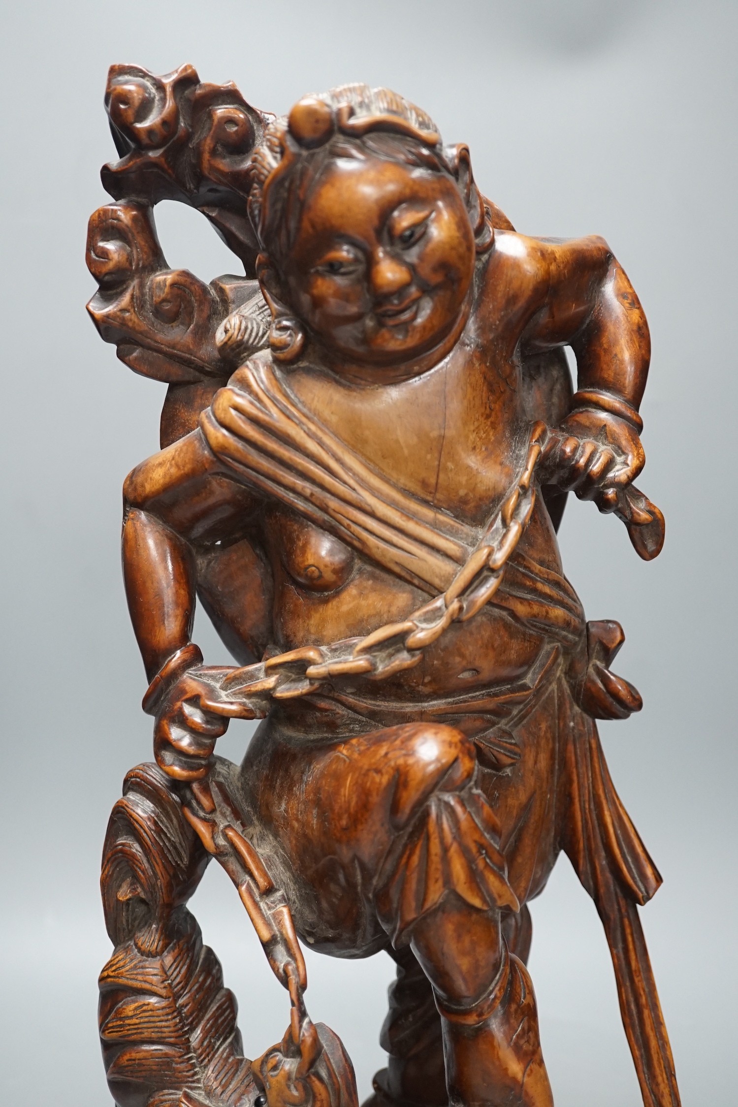 A large Chinese hardwood figure of Liu Hai, early 20th century, 47cm
